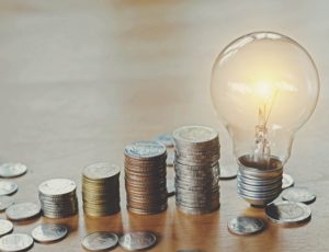 stack money coins with growing light bulb concept