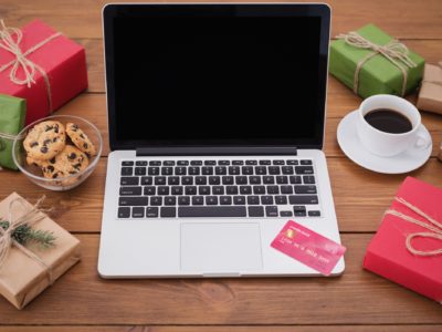 Winter holiday sales. Laptop on wooden table, copy space