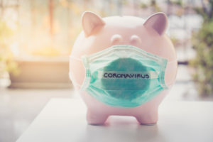 Piggy bank with Face Mask, Financial crisis and market crash due to coronavirus