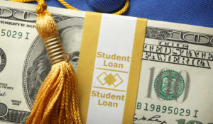 Student Loan Money On A Graduation Cap