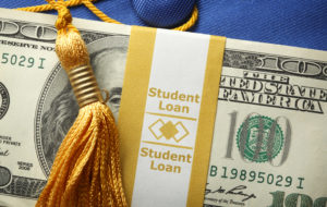 Student Loan Money On A Graduation Cap