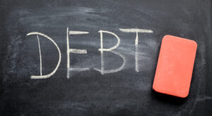 erasing debt, hand written word on blackboard being erased concept