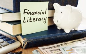 Financial Literacy and piggy bank as savings symbol.