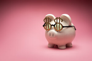 Concept Photo of a White Large Piggy Bank on Pink Background