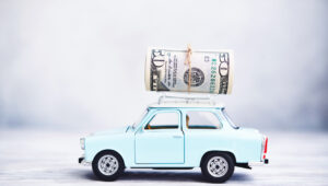 Little blue car with cash roll on roof rack