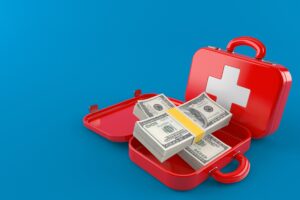 First aid kit with money isolated on blue background. 3d illustration