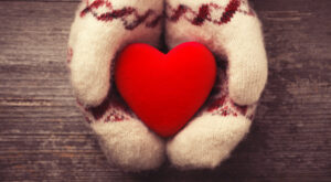 Red heart Hands in the mittens holding red heart
