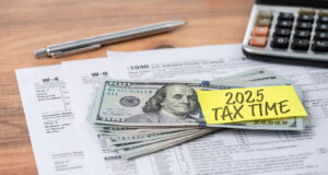 The 2025 TAX TIME note is on the hundred dollar bill. Tax concept