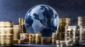Globe and stack with coins. Money makes the world go round