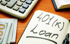 401k loan phrase in the notepad and calculator. 401k loan phrase in the notepad and calculator.
